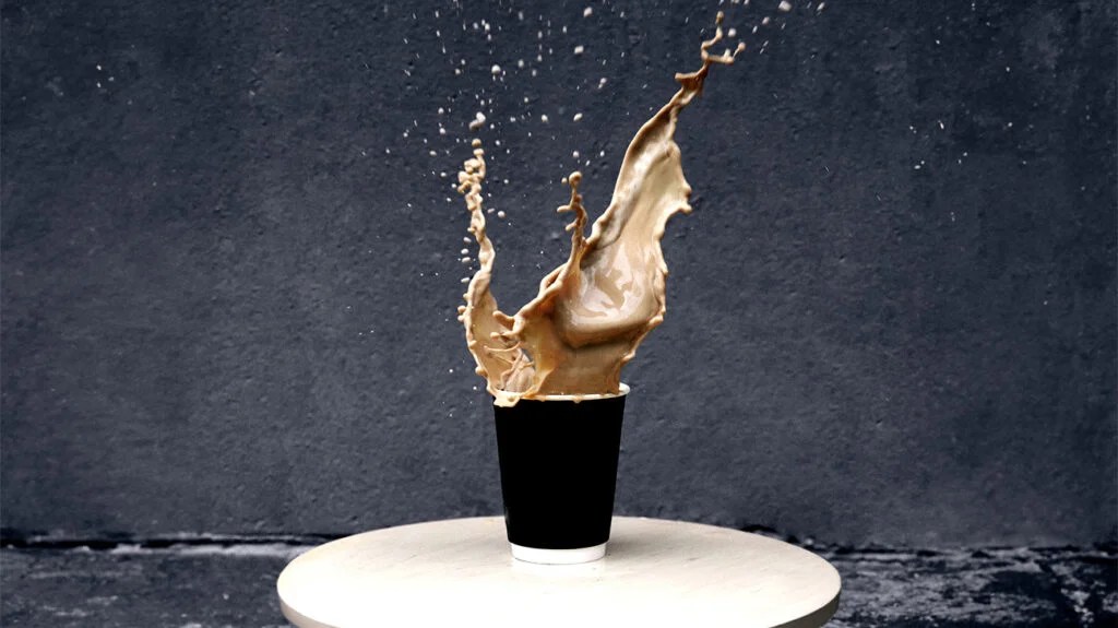 disposable cup of coffee, coffee splashing out of cup