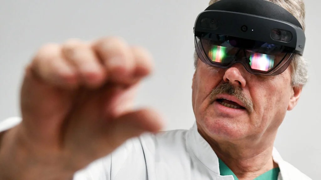 close-up portrait of older man with a white moustache wearing augmented reality glasses