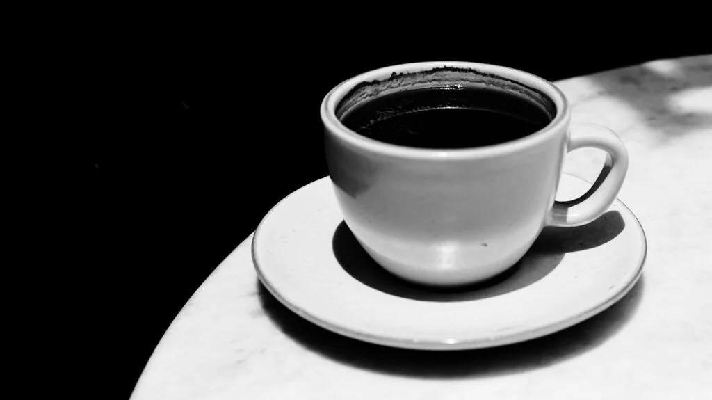 black and white photo of espresso coffee cup