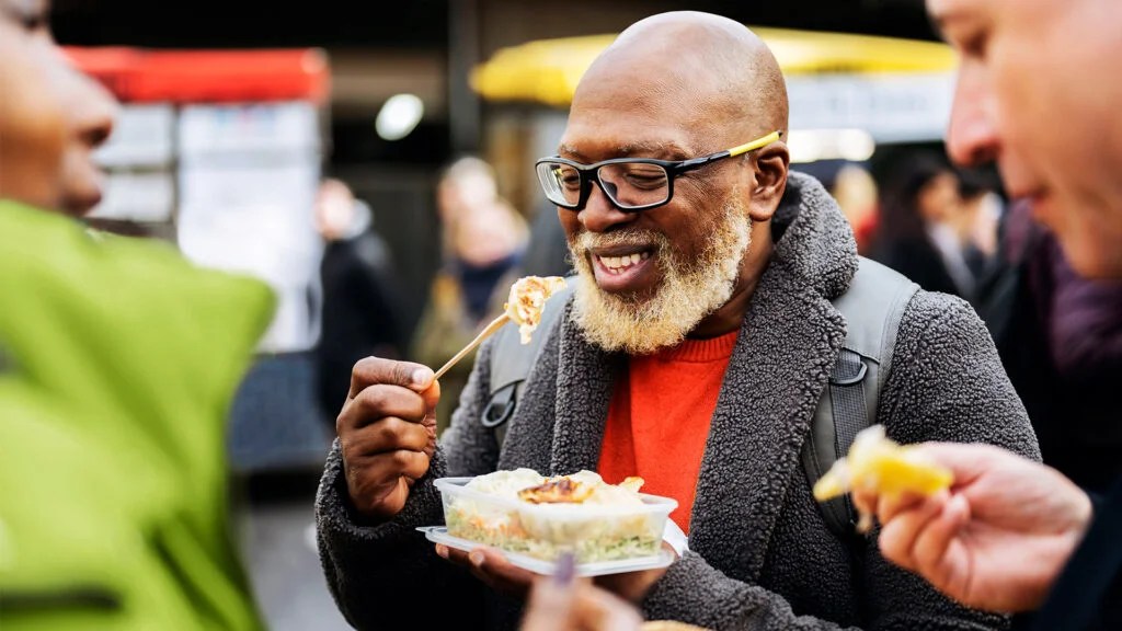 Older male eats gut healthy food outside